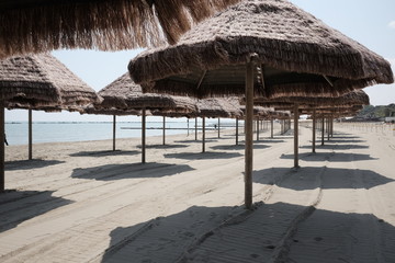 empty umbrellas on the beach of pescara