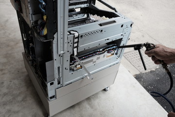 technician repairs photocopier