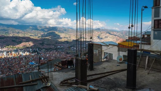 Timelapse of the city of La Paz with roof and construction on the foreground. View from the city of El Alto, Bolivia