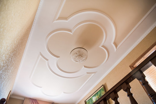 beautiful chandelier on a ceiling with a stucco molding