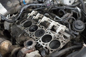 Fototapeta na wymiar Engine valve car maintenance.The cylinder block of the four-cylinder engine. Disassembled motor vehicle for repair. 