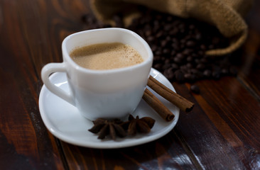 Coffee in a white cup on a wooden table.