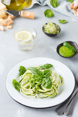 Seasonal zucchini spaghetti pasta noodles with spinach pesto sauce
