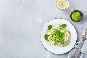 Seasonal zucchini spaghetti pasta noodles with spinach pesto sauce