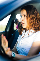 Fototapeta na wymiar Surprised woman driver