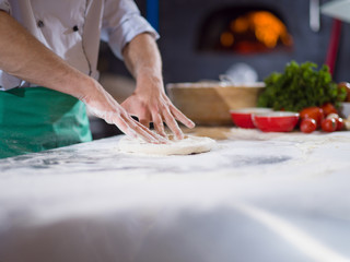chef preparing dough for pizza