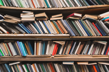 Shelves with old books in a cozy library. Book shelves in the old library. Books Concept. Background