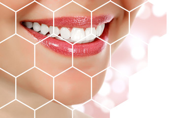 Picture of woman's smile against an abstract background with blurred lights, dental care concept