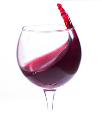 A glass with red wine on a white background. Isolate