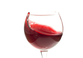 A glass with red wine on a white background. Isolate