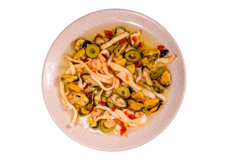 Ceramic plate with the different sea food and olives isolated on white background