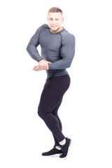 Portrait of young confident bodybuilder or gym instructor posing on white background