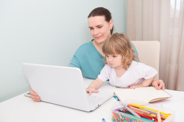 A mother working at home and parenting her child.