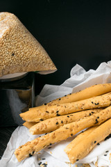 homemade snack, baked sticks with sesame and black cumin on the white napkins