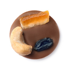 Delicious chocolate candy on white background, top view