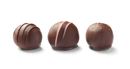 Three delicious chocolate candies on white background
