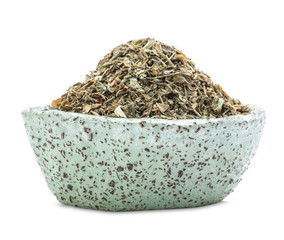 Bowl with dried parsley on white background