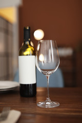 Glass and bottle of wine on table in restaurant