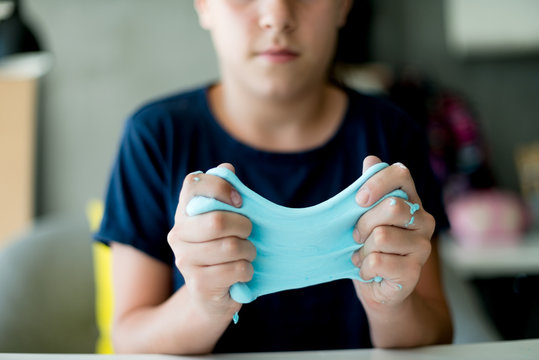 Young girl making a slime