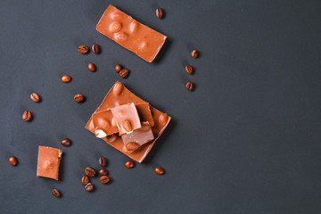 Coffee beans with chocolate on gray background.