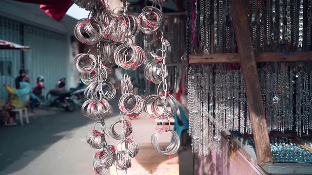Metal chains and bracelets selling in street market in Ternate, Indonesia