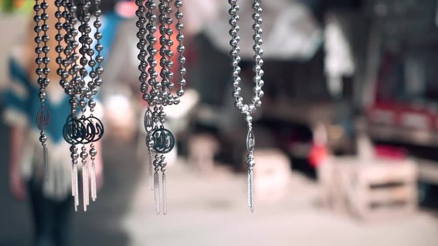 Metal chains and pendants selling in street market in Ternate, Indonesia