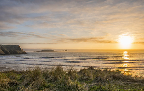 Landscape image of Wormshead Rhossili in Swansea, South Wales at sunset  