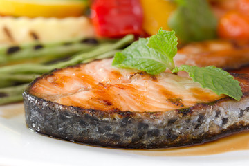 Grill Salmon with Teriyaki sauce and fresh pepper with rosemary in white dish on brown wooden table