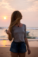 Girl on sunset background