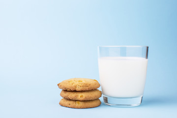 glass of milk and cookies on a blue background
