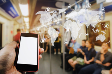 hand holding mobile smart phone with white blank screen in subway train station and virtual interface icon world map network connection diagram, internet, social media and global technology concept