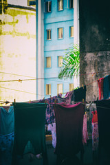 Hanged old clothes with residential and office buildings on the background.