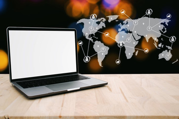 laptop notebook computer with white blank screen on desk with bokeh light at night background and icon world map network connection diagram, internet technology, social media, searching data concept