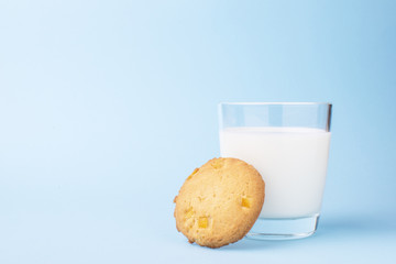 glass of milk and cookies on a blue background
