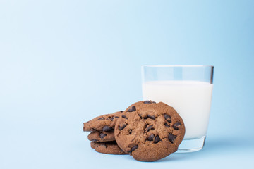 glass of milk and a school chocolate biscuit on a blue background