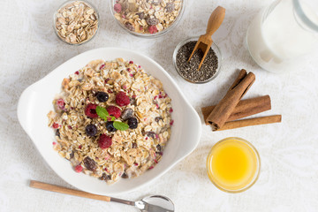 Sunny Morning with Healthy Breakfast. Muesli With Milk, Chia Seeds, Berries and Cinnamon.