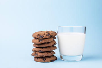 glass of milk and a school chocolate biscuit on a blue background