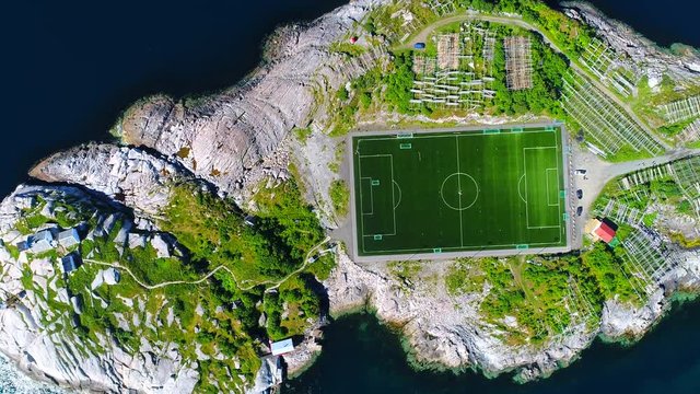 4K Aerial Movie flyover Henningsvaer village public football Field in Lofoten Island, Norway