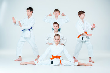 Fototapeta na wymiar The group of boys and girl fighting at Aikido training in martial arts school. Healthy lifestyle and sports concept