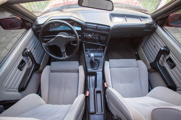 Interior of old retro car with front textile sport seats