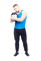 Isolated portrait of well-muscled athletic man holding container with sports nutrition