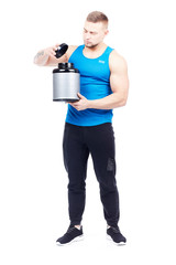 Isolated portrait of well-muscled athletic man holding container with sports nutrition