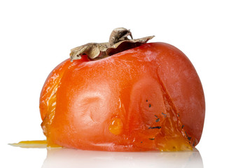 Spoiled rotten persimmon fruit isolated on white