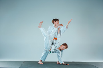 The two boys fighting at Aikido training in martial arts school. Healthy lifestyle and sports concept