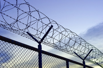 Fence with razor barbed wire
