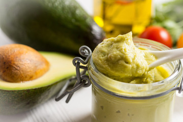 Homemade Avocado Spread Guacamole in Glass Jar. Vegan Raw and Healthy Food.