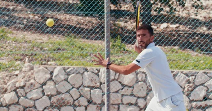 Slow motion of a tennis player hitting the ball during a tennis game