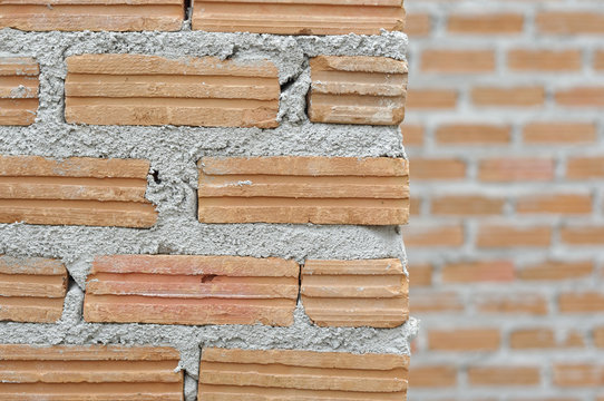 Edge of red brick wall