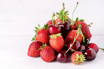 Fresh Beautiful Ripe Berries on a White Wooden Background Sweet Strawberries and Cherry Copy Space