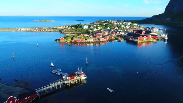 Aerial footage of small fishing village of Hamnoy on Lofoten islands in Norway, popular tourist destination with its typical red houses and natural beauty. Aerial 4k Ultra HD.